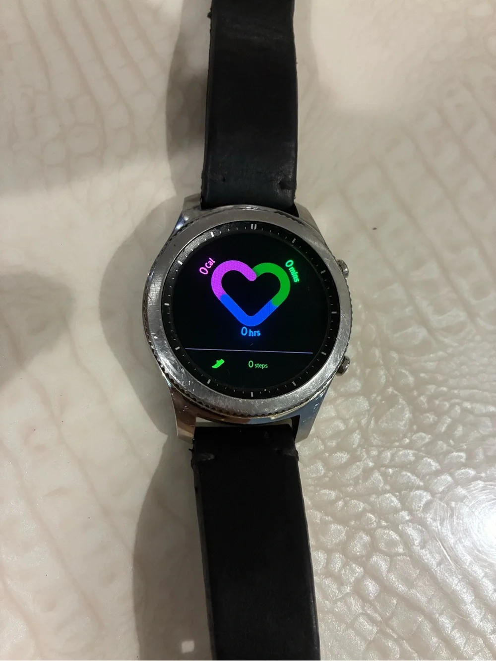 Samsung Silver Smartwatch with Black Strap and Blue Display